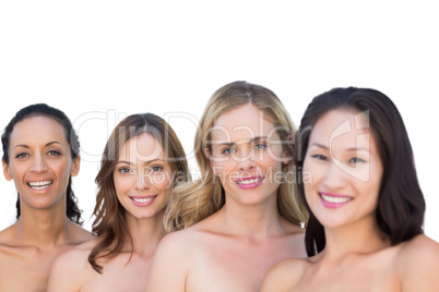 Smiling nude models posing in a line with brunette on background
