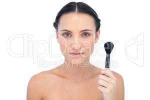 Gorgeous natural model holding powder brush