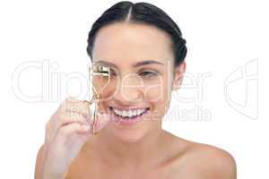 Smiling natural model with eyelash curler