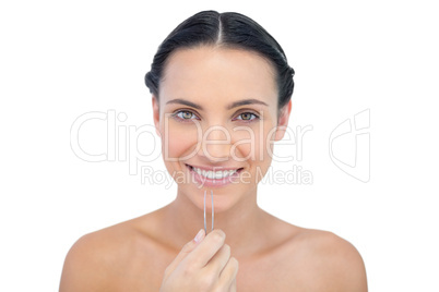 Cheerful young model with tweezers