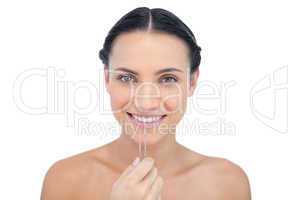 Cheerful young model with tweezers
