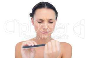 Serious natural young model using nail file