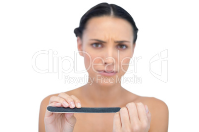 Frowning model with nail file