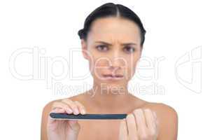 Frowning model with nail file