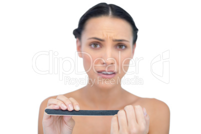 Concerned young model with nail file