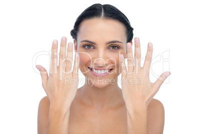 Cheerful natural model raising hands