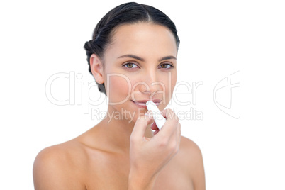 Sensual young natural model applying lip balm