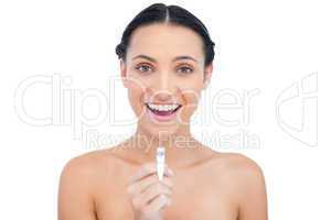 Enthusiastic young brunette holding nail clippers