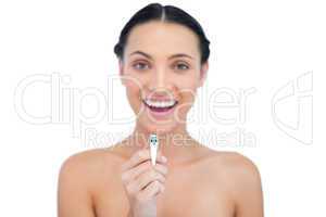 Enthusiastic young brunette holding nail clippers