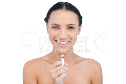 Cheerful brunette posing with nail clippers