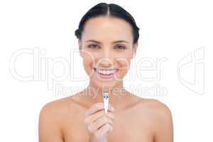 Cheerful brunette posing with nail clippers