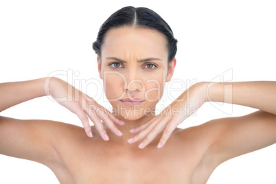 Serious attractive nude model gesturing