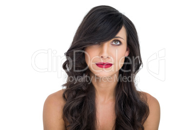 Pretty dark haired woman posing with red lips looking up