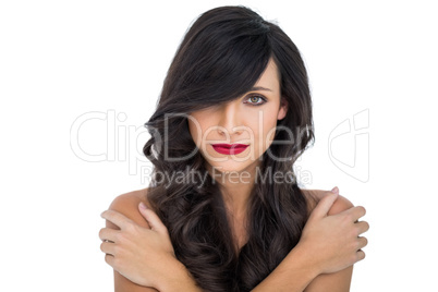Glamorous brunette posing crossing arms on her shoulder