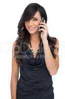Cheerful brown haired model posing holding smartphone