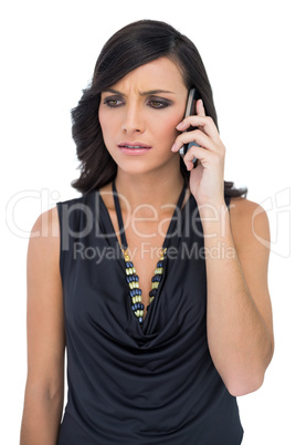Frowning elegant brown haired model talking on the phone