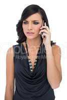 Frowning elegant brown haired model talking on the phone