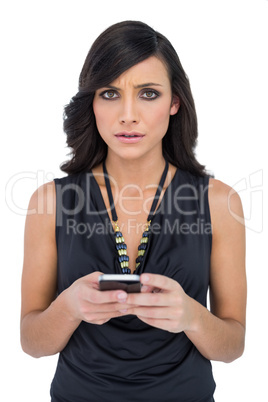 Serious elegant brown haired model texting