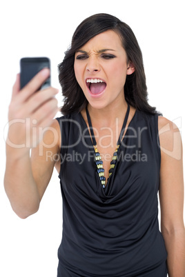 Angry elegant brown haired model screaming to her phone