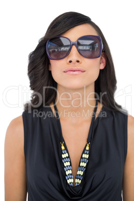 Serious elegant brunette wearing sunglasses