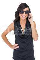 Cheerful elegant brunette on the phone wearing sunglasses
