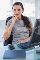 Thoughtful businesswoman sitting on her swivel chair