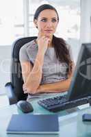Pensive businesswoman sitting on her swivel chair