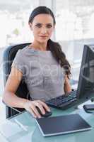 Attractive businesswoman working on her computer
