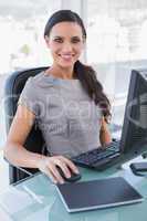 Cheerful businesswoman working on her computer