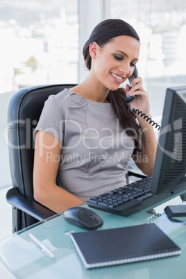 Attractive businesswoman answering phone