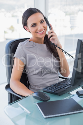 Smiling attractive businesswoman answering phone