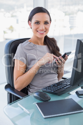 Smiling businesswoman using calculator