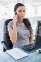 Serious gorgeous businesswoman having a phone call