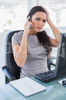 Annoyed gorgeous businesswoman having a phone call