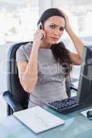 Annoyed gorgeous businesswoman having a phone call