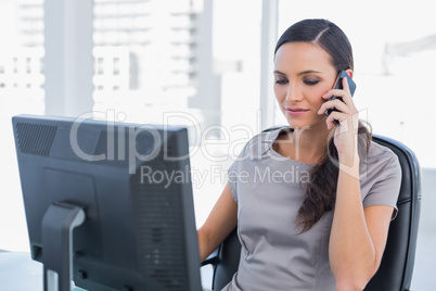Dark haired businesswoman having a phone conversation