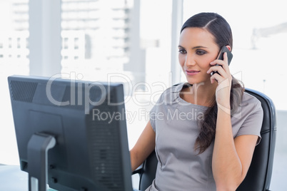 Peaceful dark haired businesswoman having a phone conversation