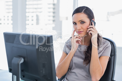 Annoyed attractive businesswoman having a phone conversation