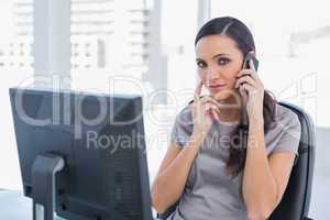 Annoyed attractive businesswoman having a phone conversation