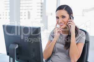 Happy attractive businesswoman having a phone conversation