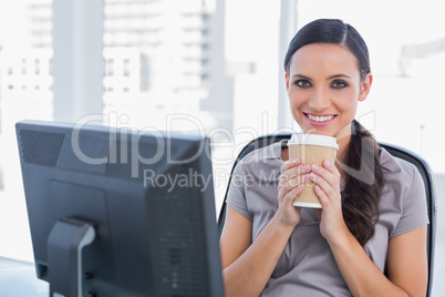 Happy attractive businesswoman having coffee