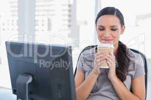 Happy attractive businesswoman holding coffee