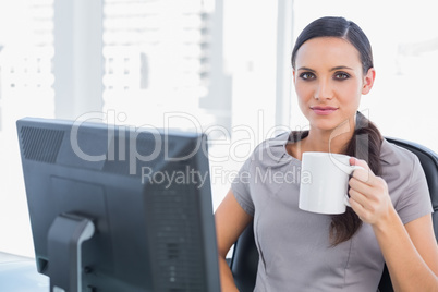 Attractive businesswoman holding mug