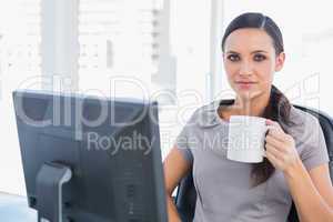 Attractive businesswoman holding mug