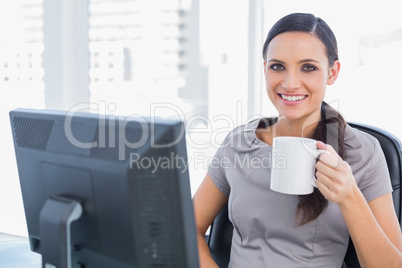Smiling attractive businesswoman holding mug Smiling attractive businesswoman holding mug