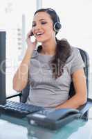 Smiling attractive secretary wearing headset