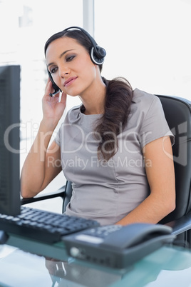 Relaxed attractive secretary wearing headset