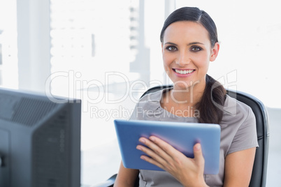 Cheerful attractive secretary using tablet pc