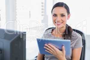 Cheerful attractive secretary using tablet pc