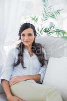 Gorgeous brunette sitting on the couch